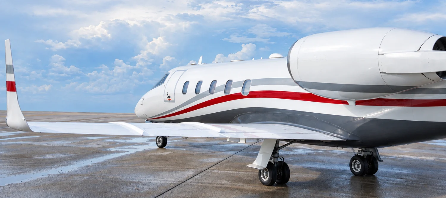 Learjet 60 on a wet ramp at an airport