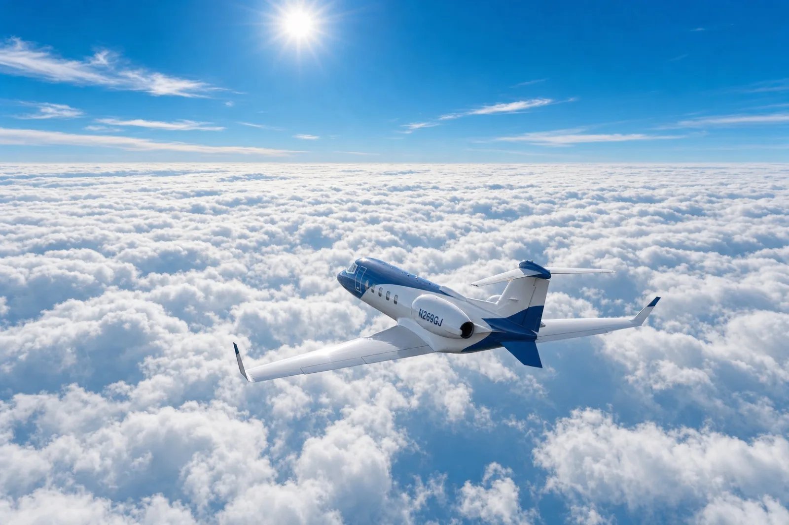 Learjet in flight above cloud cover